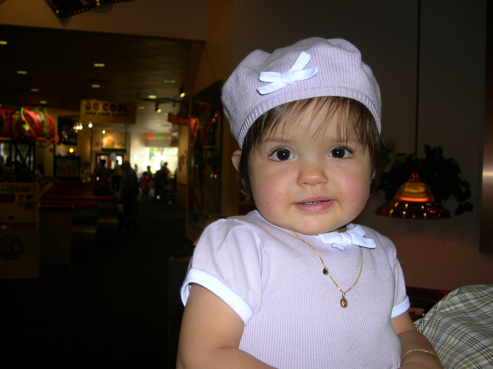 A close up of baby Nicole, with a matching lavender sweater and beret.